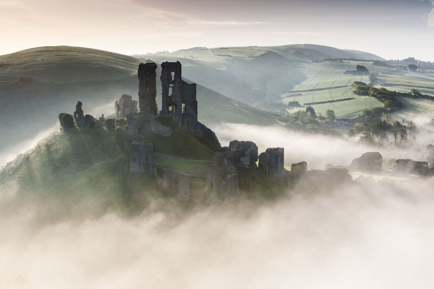 Ruins of Corfe Castle rising from above the fog