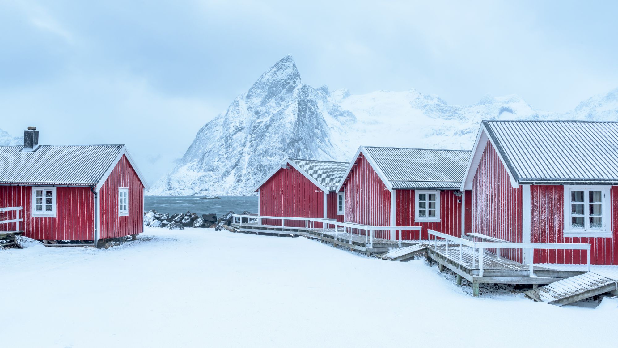 Red cabins and mountainn in winter